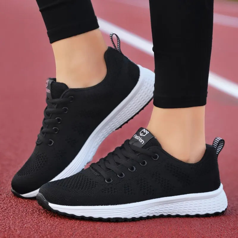 Women's athletic shoes in pink and black – lightweight, breathable sneakers for running, gym, and fitness.