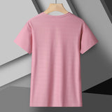Woman wearing reflective running T-shirt made of breathable elastic silk – ideal for fitness, yoga, and outdoor workouts